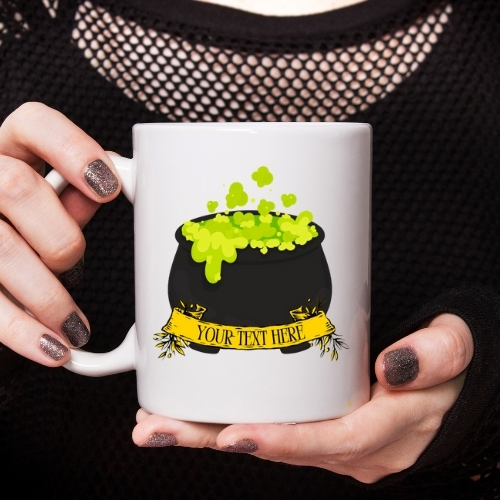 Ceramic Halloween mug depicting a cauldron filled with bubbling green liquid, perfect for festive drinks during the spooky season.