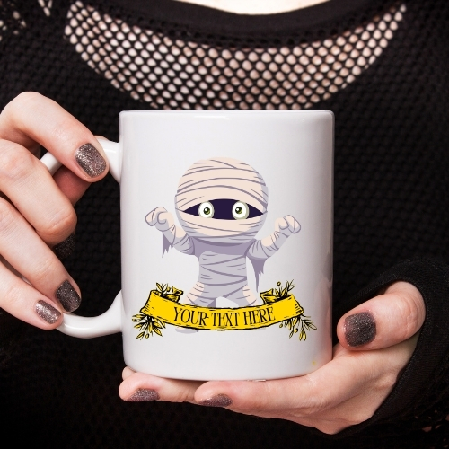 Halloween ceramic mug featuring a cartoon mummy with raised hands, wrapped in white bandages, perfect for spooky Halloween drinks.