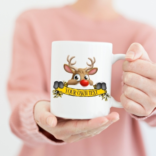 Ceramic Christmas mug featuring a cute cartoon reindeer peeking over the edge, ideal for adding holiday cheer to festive beverages.